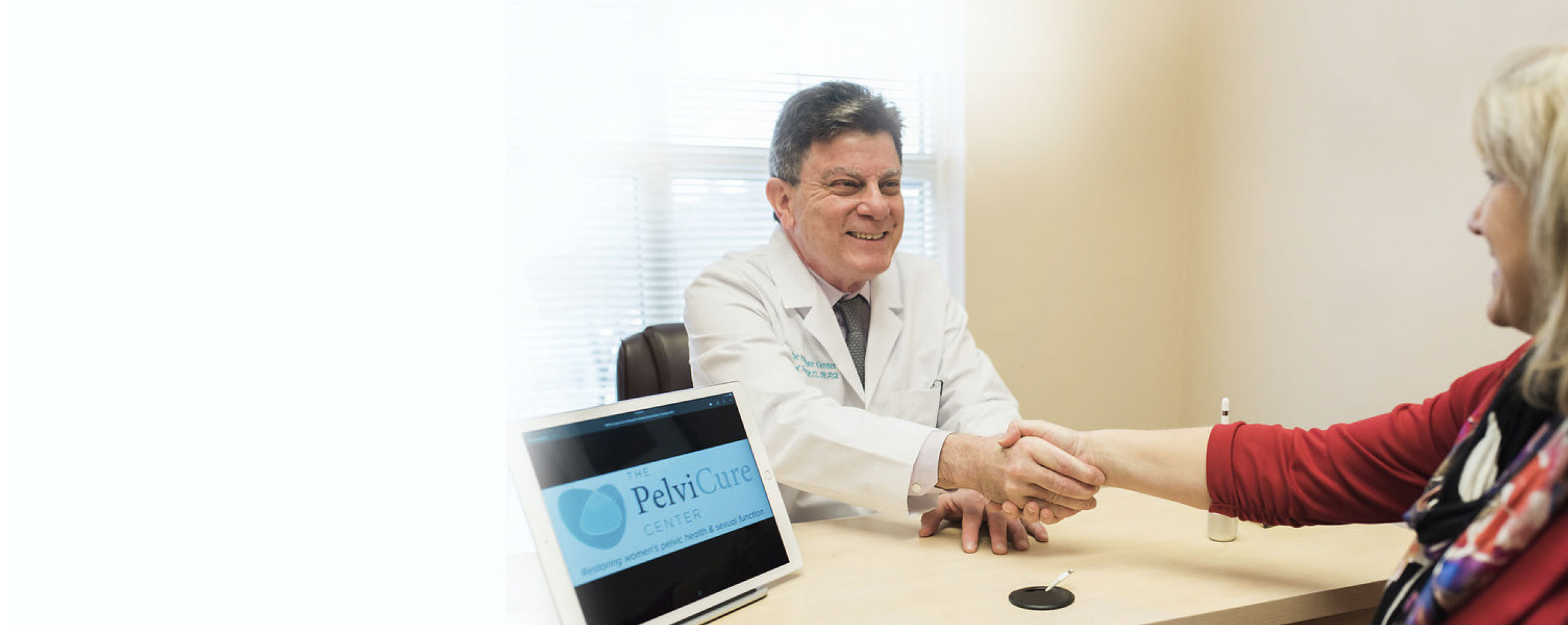 Dr. Kamal Hamod shaking hands with a female patient